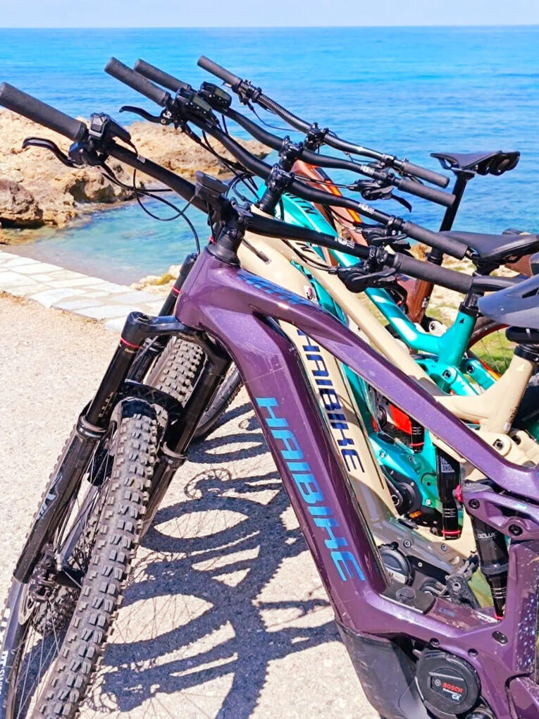 Premium electric mountain bike parked at the beach in Greece