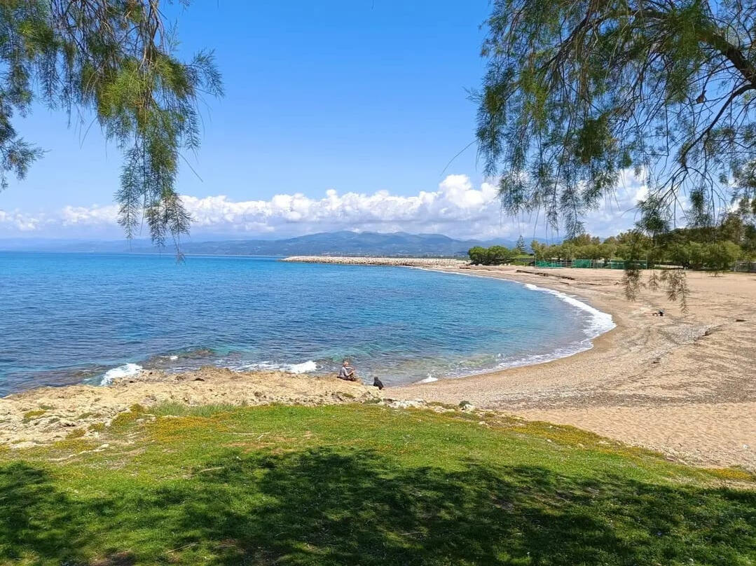Peaceful beach trail along the Greek coast with turquoise waters and sandy paths